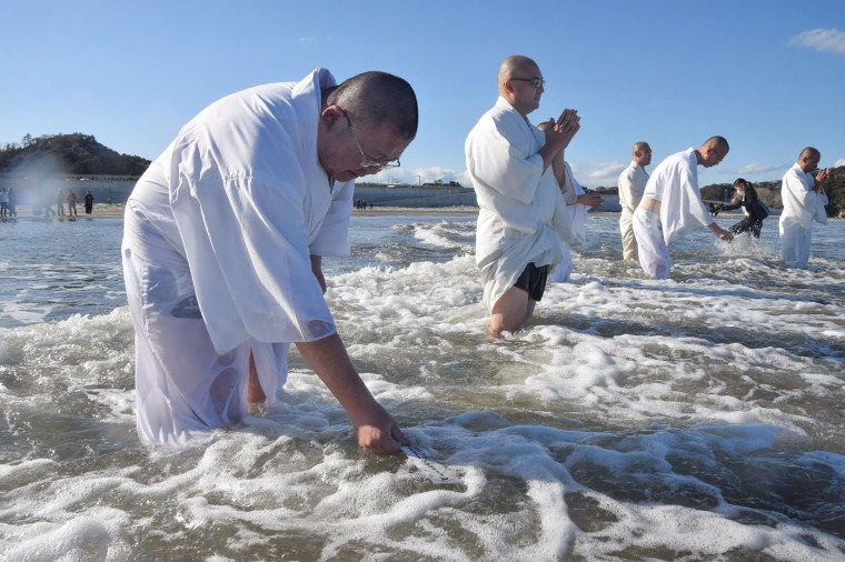 Image: Japanese monks pray for victims of the 2011 earthquake and tsunami disaster during a memorial service on the coast in Iwaki, Fukushima prefecture.