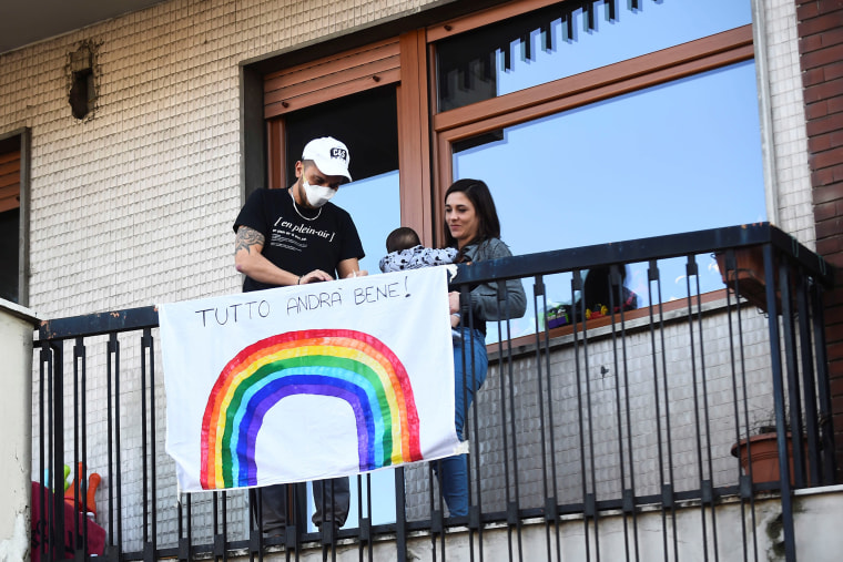 Image: An Italian family place a banner on a balcony that reads "everything will be fine" after Italy orders a lockdown on the whole country aimed at beating the coronavirus, in Turin