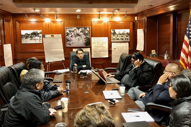 Navajo Nation President Jonathan Nez, center.