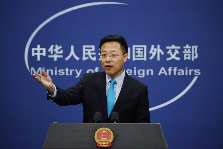 Image: Chinese Foreign Ministry new spokesman Zhao Lijian gestures as he speaks during a daily briefing at the Ministry of Foreign Affairs office in Beijing.