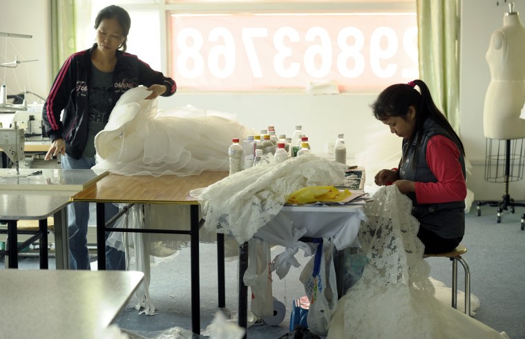 Dressmakers work on wedding gowns in the workshop of Divine Bridal Co. in the southern Chinese city of Shenzhen.