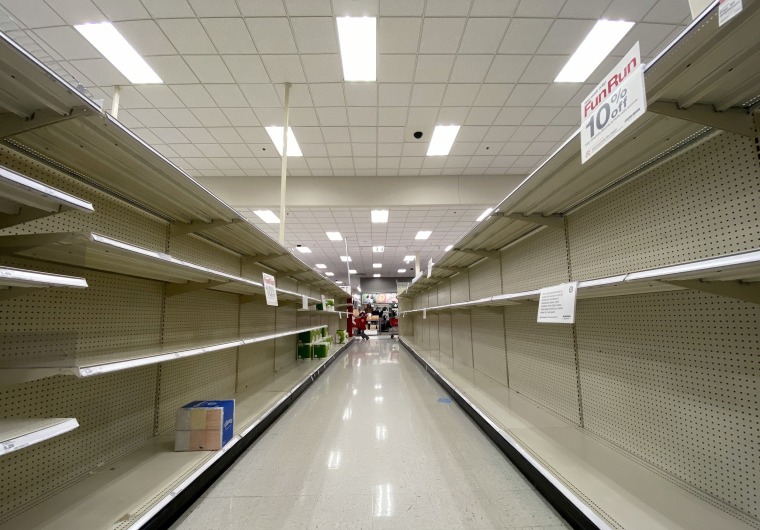 Empty shelves normally stocked with hand wipes, hand sanitizer and toilet paper at a Target store in Arlington, Va.