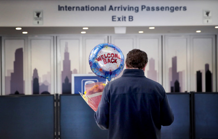Image: A man waits for a traveler at the international terminal of O'Hare Airport in Chicago on March 13, 2020, the last day for European travelers to fly into the United States in an effort to stem the spread of coronavirus. The travel ban was later exte