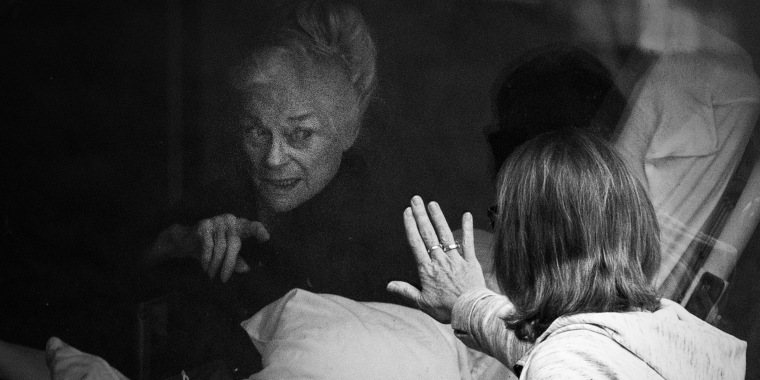"At one point in my book, a new father, with his baby strapped to his chest, finds a way to look through the window of a makeshift ward just to lay eyes on his stricken, unconscious wife," writes Karen Thompson Walker. "Last week, pictures emerged from Seattle showing relatives of quarantined nursing home residents doing just that."