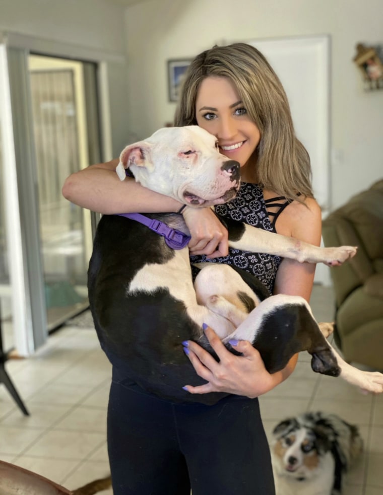 Amber Batteiger cradles an American Bulldog.