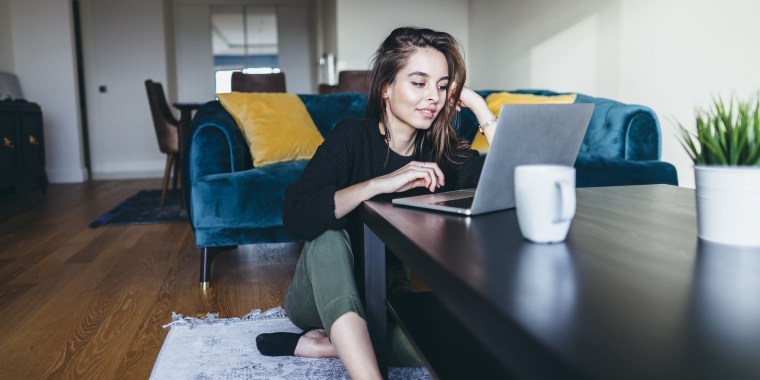 Young woman using laptop at home