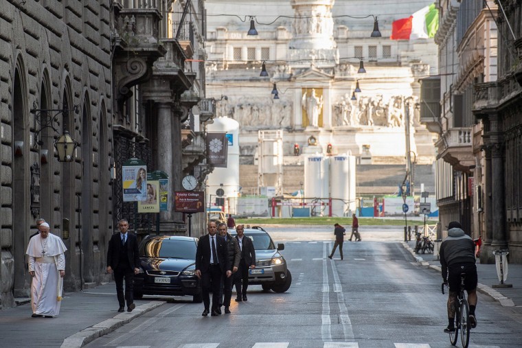 Image: Pope Francis walks in a deserted Rome to pray at two shrines for the end of the coronavirus pandemic, in Rome