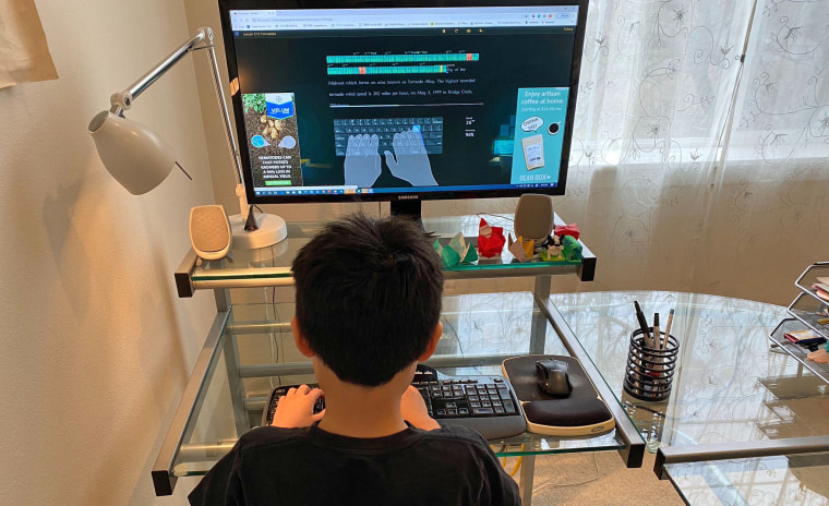 Takumi Ohno's third-grade son practices his typing skills.