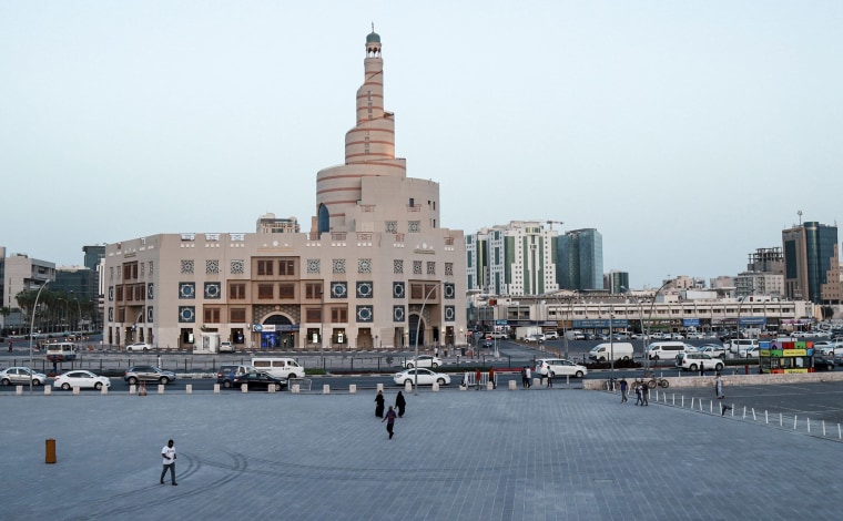 Image: An almost deserted Souq Waqi in Qatar's capital Doha, with the spiral minaret of the mosque at the Abdulla Bin Zaid Al Mahmoud Islamic Cultural Center in the background