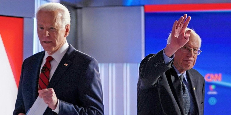 Democratic presidential hopefuls Joe Biden and Bernie Sanders leave the stage after a debate in Washington on March 15, 2020.