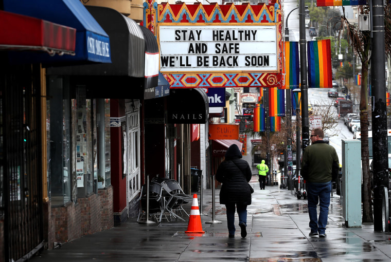 Image: Pedestrians walk by the Castro Theatre in San Francisco