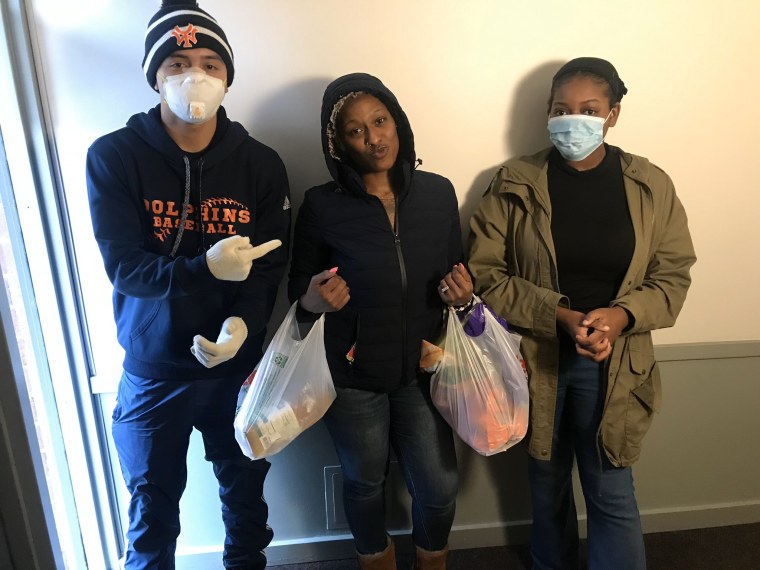 Jalen Kobayashi, Deja Swint, and Alycia Kamil, volunteers from the youth-led anti-gun violence group Good Kids Mad City, deliver groceries to neighbors in Chicago.