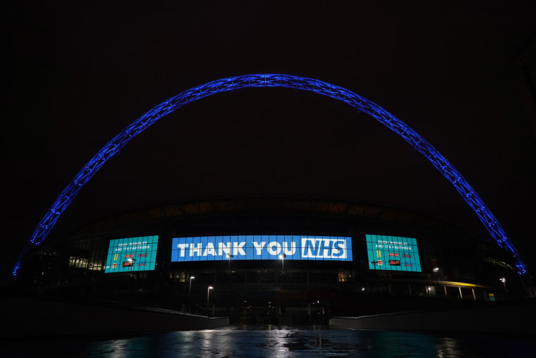 Image: Wembley Stadium in London lights up its arch to show support for National Health Service workers.