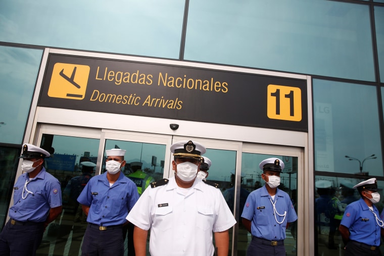 Image: Sailors with the Peruvian Navy stand guard outside Jorge Chavez International Airport after the Peruvian government closed the country's borders in response on Tuesday