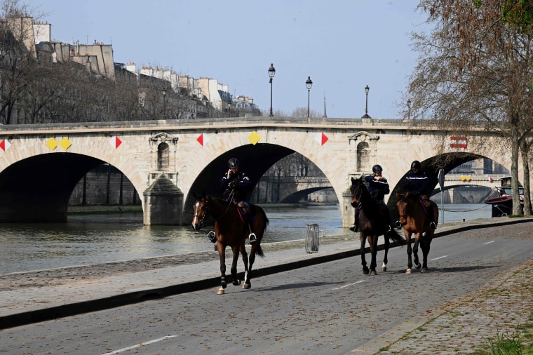 Image: Mounted policemen patroling along the banks of the Seine river, on the fourth day of a strict lockdown in France aimed at curbing the spread of COVID-19 caused by the novel coronavirus