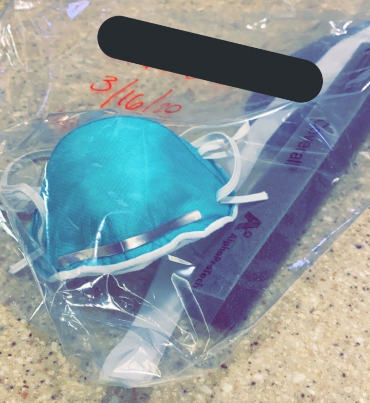 A nurse in Illinois shared a photo of her N-95 mask she keeps in a bag labelled with her name. Many healthcare workers are being asked to ration their personal protective equipment.