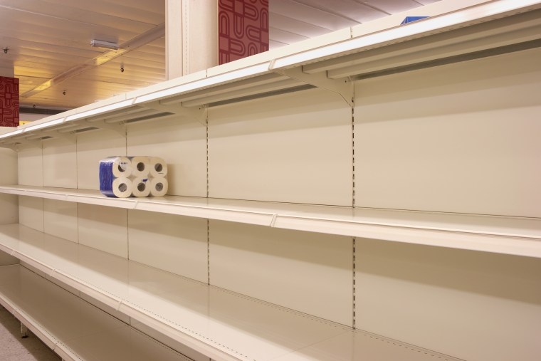 Toilet rolls on empty shop shelf