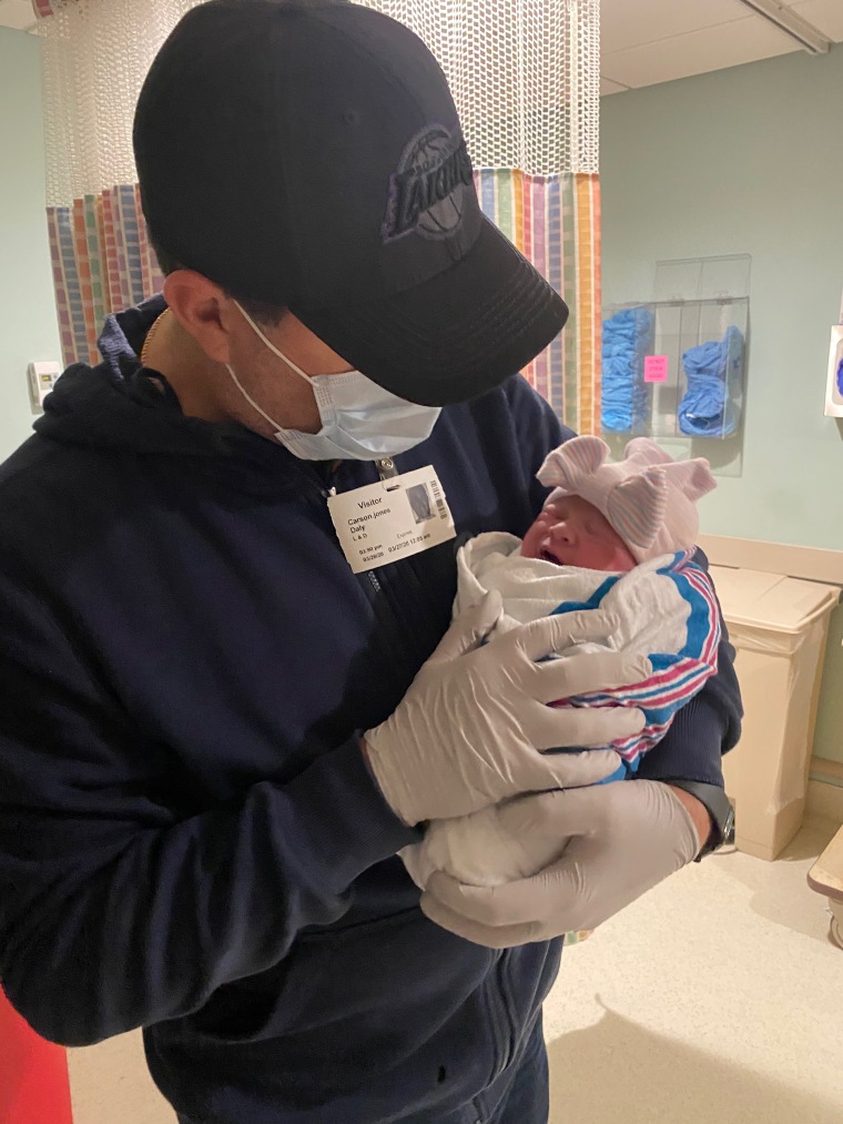 Carson Daly holds his newborn daughter shortly after her arrival.