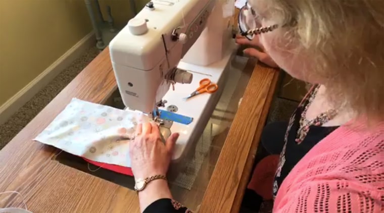 Sheri Yeisley sews a homemade face mask.