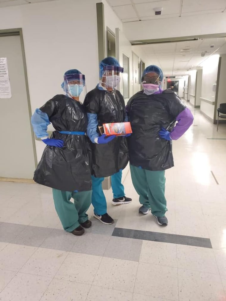 Photos show nurses wearing appropriate protective gear beneath black trash bags. 