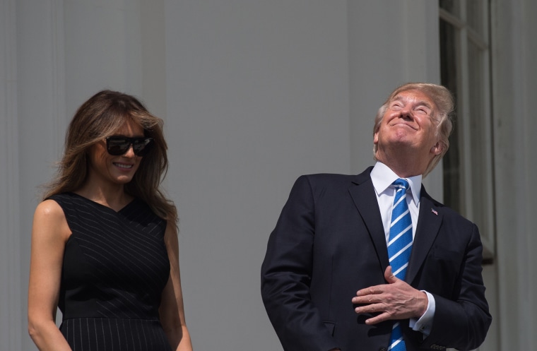 Image: President Donald Trump and first lady Melania Trump stand on the balcony of the White House to watch the partial solar eclipse in Washington on Aug. 21, 2017.
