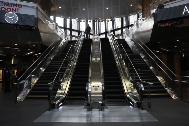 Image: A lone person enters an empty Fulton subway station during the evening rush, as people react to coronavirus disease (COVID-19) in New York