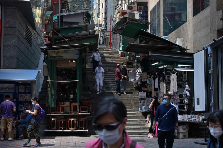 Image: Pedestrians wear face masks in Hong Kong on Monday.