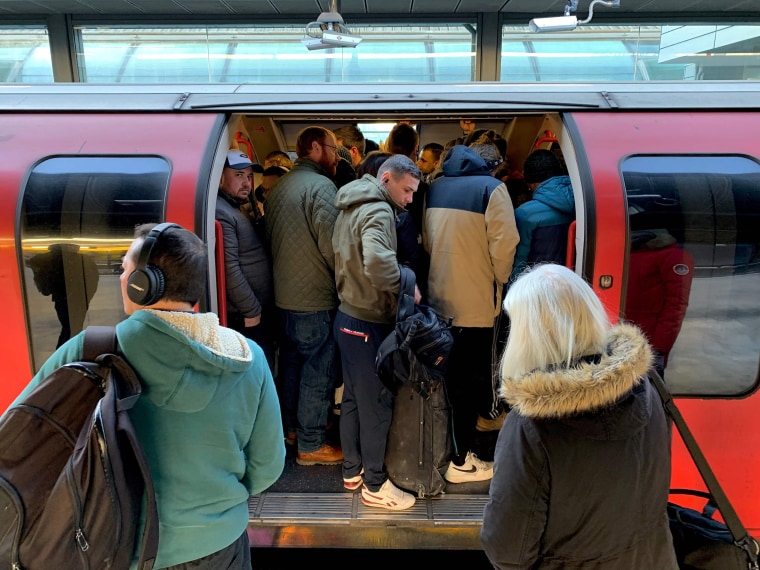 Image: Passengers squeeze into a busy Underground train at Stratford station in east London on Monday.