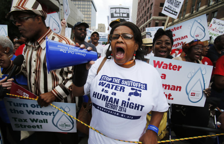 People gather to protest against the mass water shut-offs to Detroit citizens behind in their payments during a demonstration in downtown Detroit