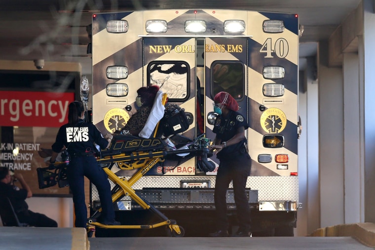 Image: EMS personnel bring a patient into the emergency center at Ochsner Baptist Medical Center in New Orleans on March 25, 2020.