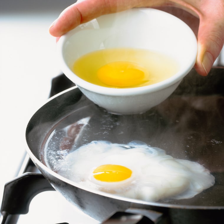 Eggs being poached in frying pan