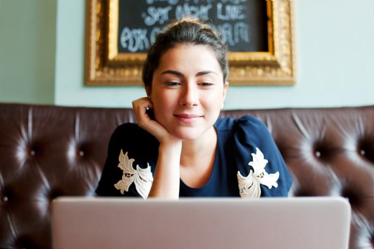 Woman looking at screen in cafe.