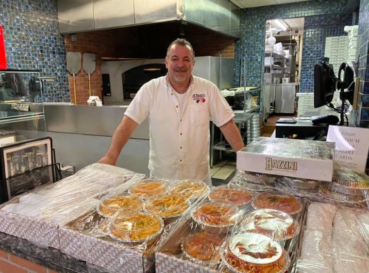 Gino Iossa, owner of Rocco's Tuscany Bar and Grill, with food prepared for medical workers by his restaurant staff.