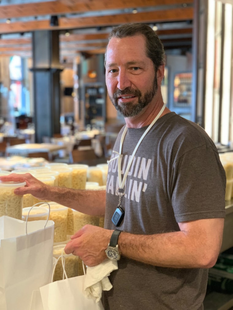 Chef Chris Wilson prepares takeaway food for his staff at Emeril's Restaurant. 