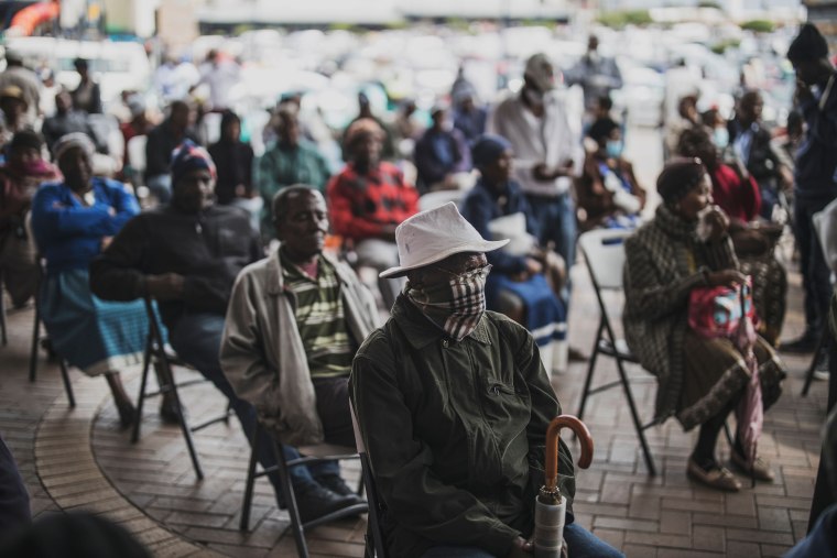 Image: An elderly man at a SASSA (South African Social Security Agency) pay-point in Soweto covers his mouth on March 30, 2020 while queuing.