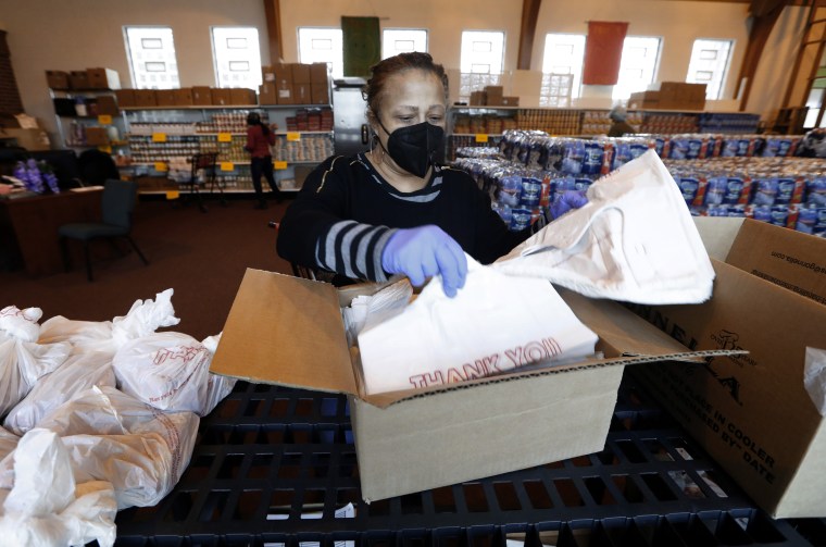 Image: Rev. Roslyn Bouier, Director of the Brightmoor Connection Food Pantry prepares bags of food in Detroit