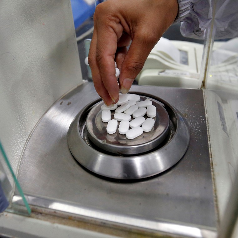 FILE PHOTO: A pharmacist checks weight of Paracetamol tablets inside a lab of a pharmaceutical company on the outskirts of Ahmedabad