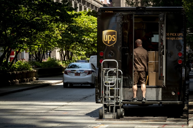Image; A UPS driver unloads packages from a truck in Chicago in 2019.