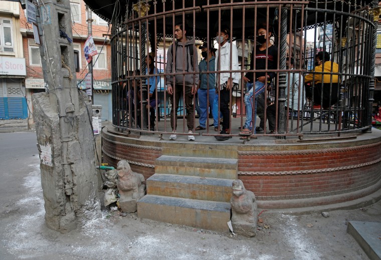People defying the lockdown are put inside an enclosure along the street, as a punishment during the eighth day of the lockdown imposed by the government amid concerns about the spread of coronavirus disease (COVID-19) outbreak, in Kathmandu