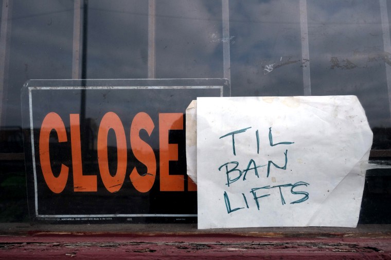 Image: A local business closes until the stay at home order is lifted in Detroit on March 24, 2020.