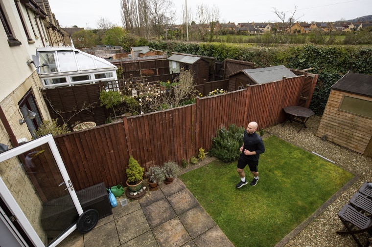 James Campbell runs a charity marathon to raise funds for the NHS in his garden on Wednesday.