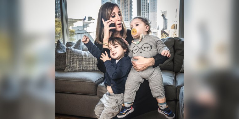 MSNBC anchor and "Morning Joe First Look" co-anchor Yasmin Vossoughian on the phone while holding her sons Azur and Noor.