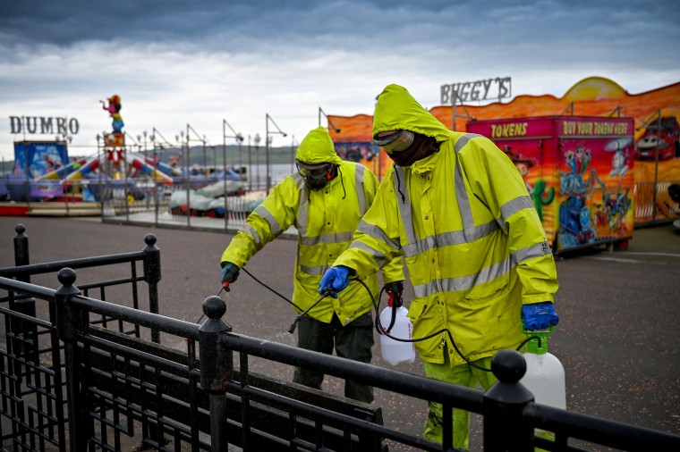 Image: Cleaners disinfect surfaces in Largs, Scotland, on April 4, 2020.