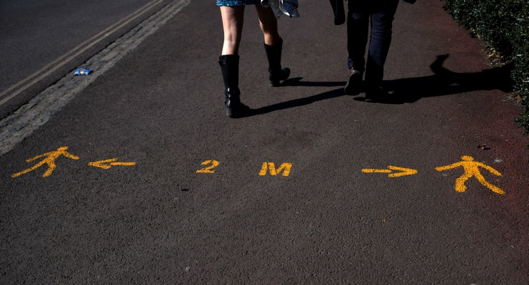 Image: Markings to help people maintain social distancing on the pavement at Greenwich Park in London on April 4, 2020.