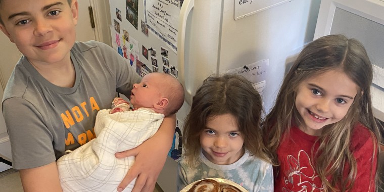 Carson Daly's son, Jackson, 11, holds baby Goldie alongside his other sisters, London, 5, and Etta, 7.