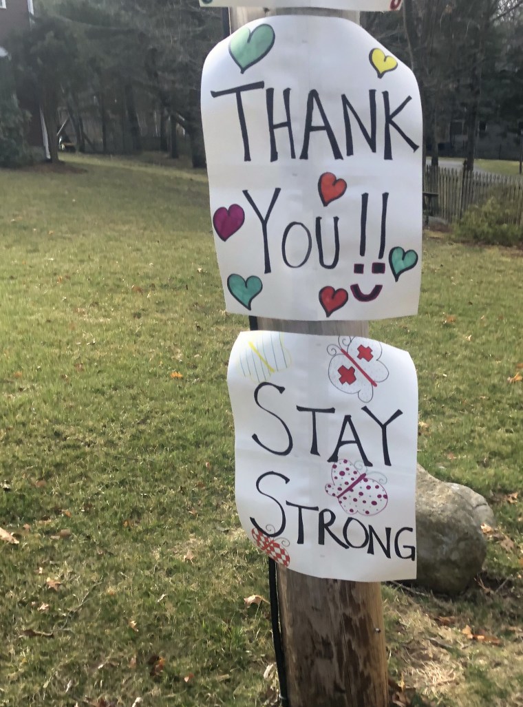 In addition to the "thank you" signage, Colombo's neighbors waved to her from their doorways as she drove to her home.
