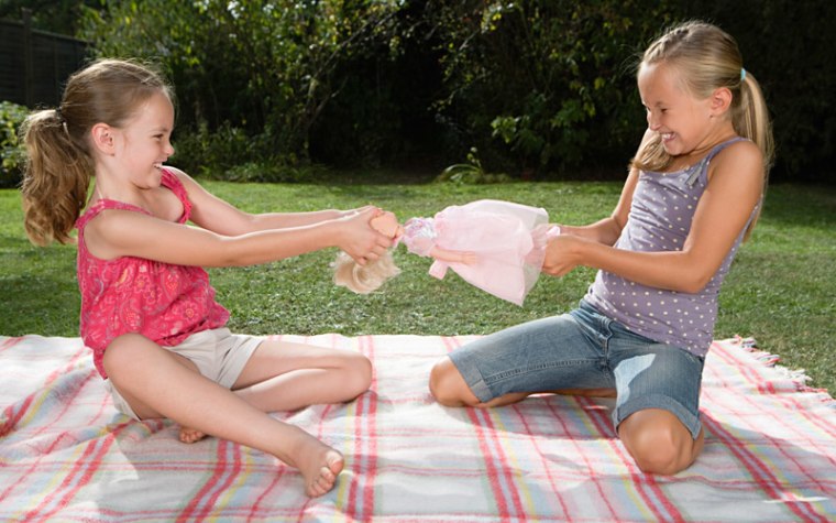 Young girls fight over a doll.