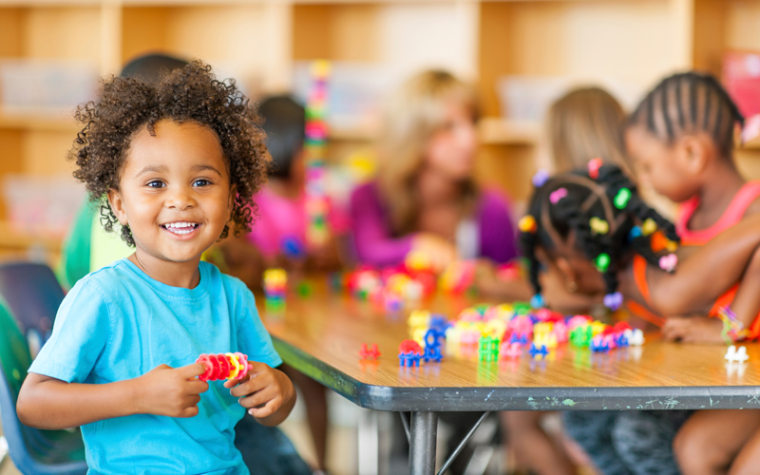 Young children play with classroom toys.