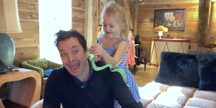 Fallon pretends to be afraid of his daughter's handcrafted paper snake.
