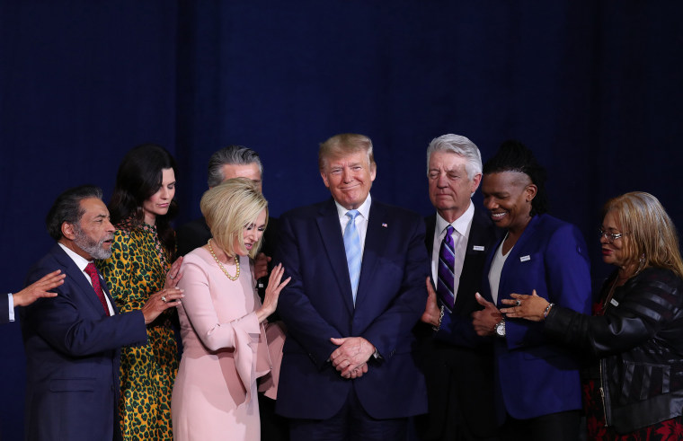 Faith leaders pray over President Donald Trump during an \"Evangelicals for Trump\" campaign event at the King Jesus International Ministry in Miami on Jan. 3, 2020.